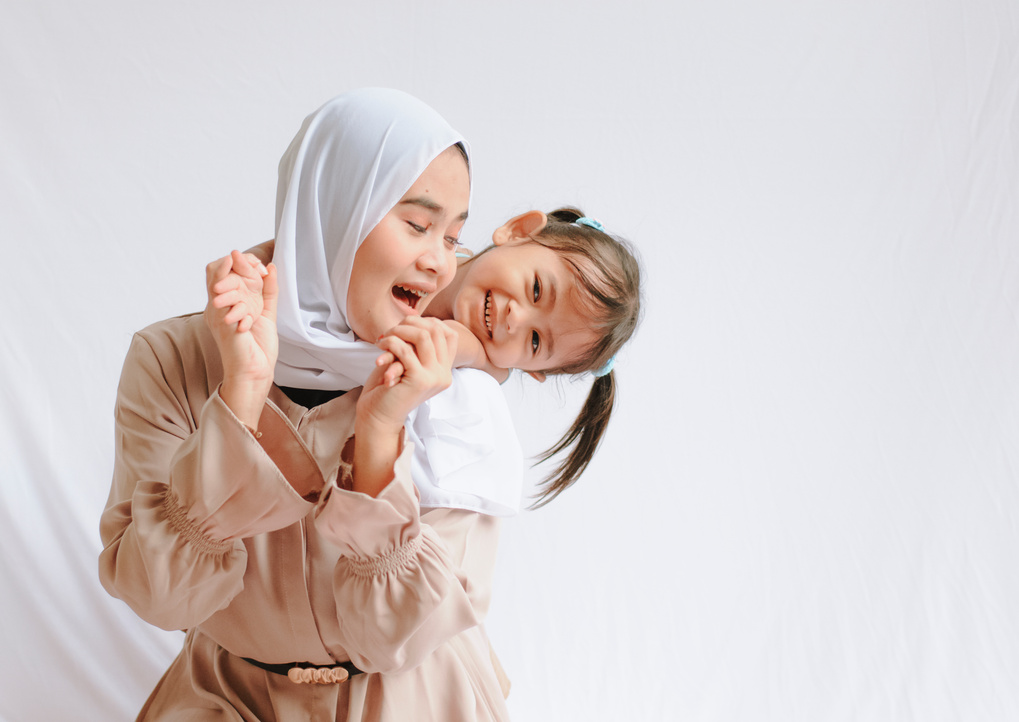 Portrait of a Happy Mother in Hijab and Her Child
